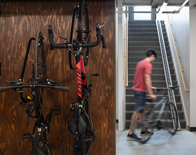 man taking bike from storage area