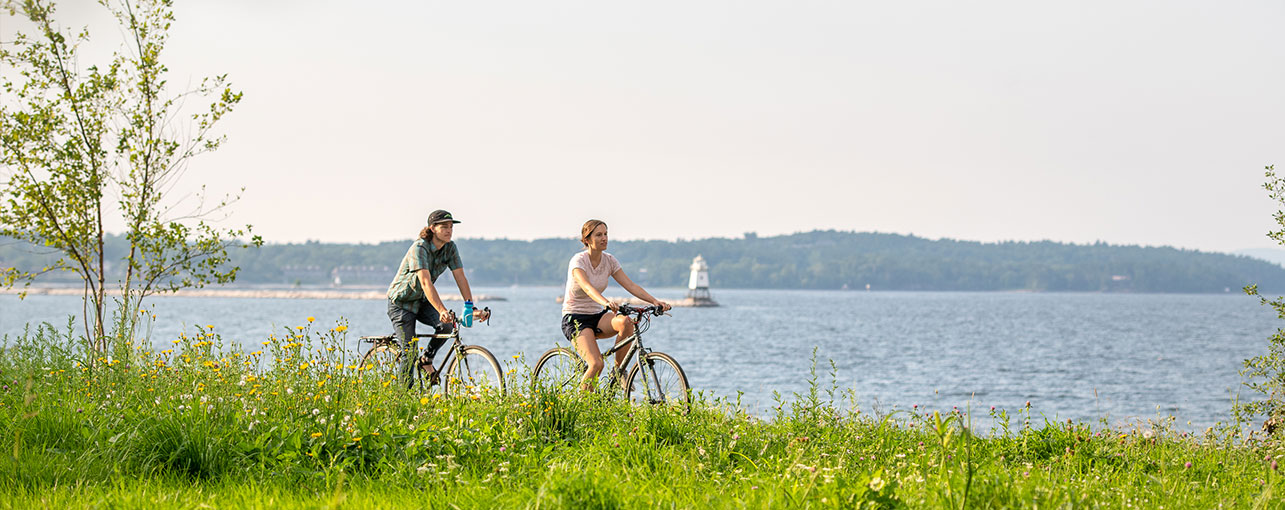 Man and Woman biking on waterfront