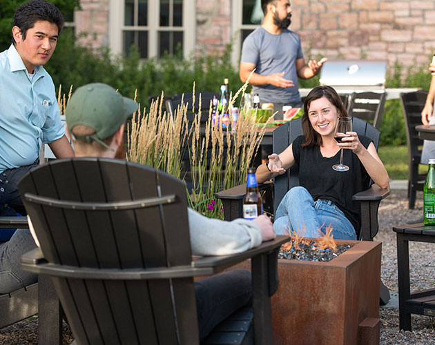 Friends drinking and grilling on patio