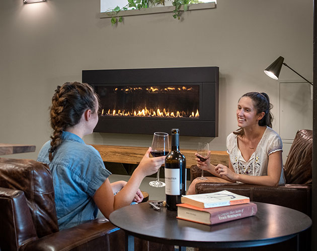 residents at Liberty House chatting by the fireplace