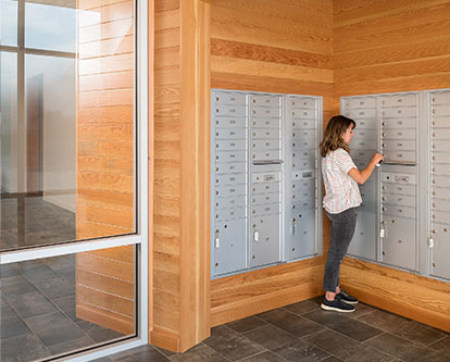 Woman getting mail from lockbox